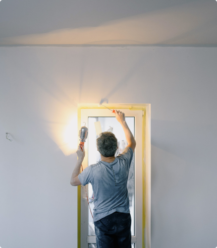 Man painting and making repairs to a rental property