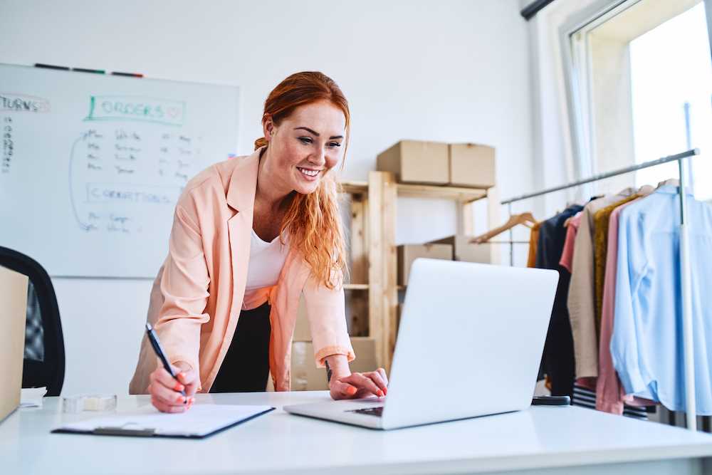 Business owner checking orders on laptop