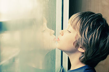 Boy looking out window