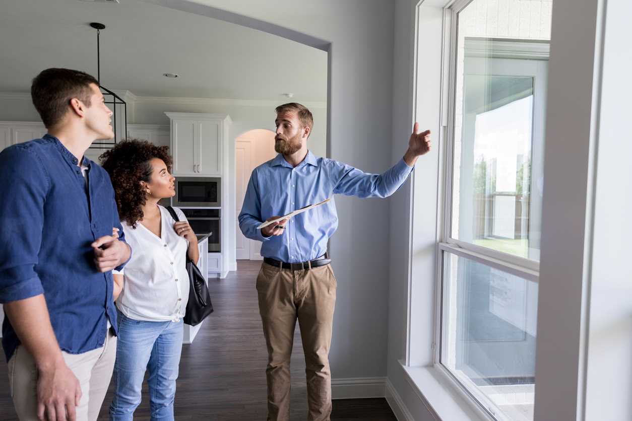 Real estate agent showing home to a couple