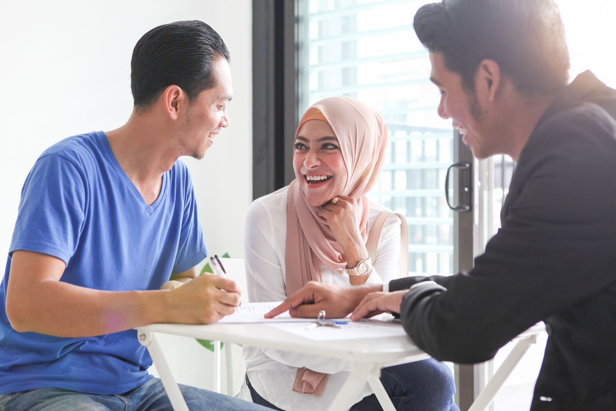 Couple signing a prenup agreement