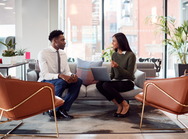 Woman talking to male employee