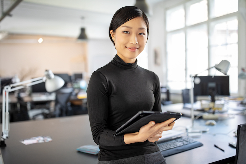 Confident Asian businesswoman in office