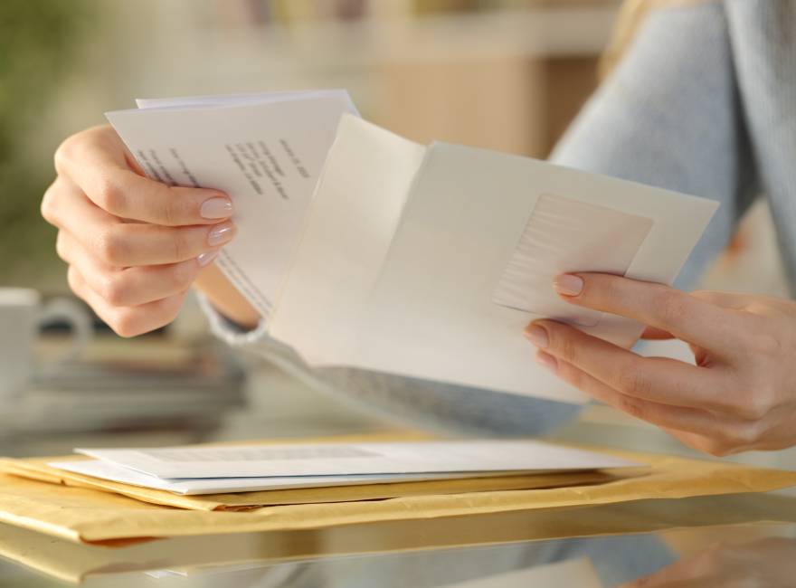 Landlord putting letter into envelope