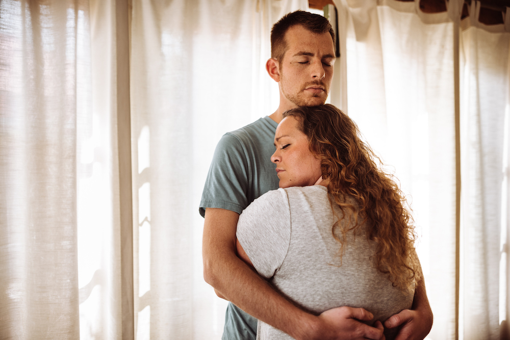 Couple embracing with eyes closed