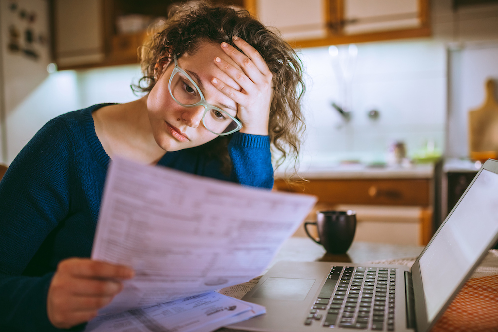 Worried woman reviewing a bill