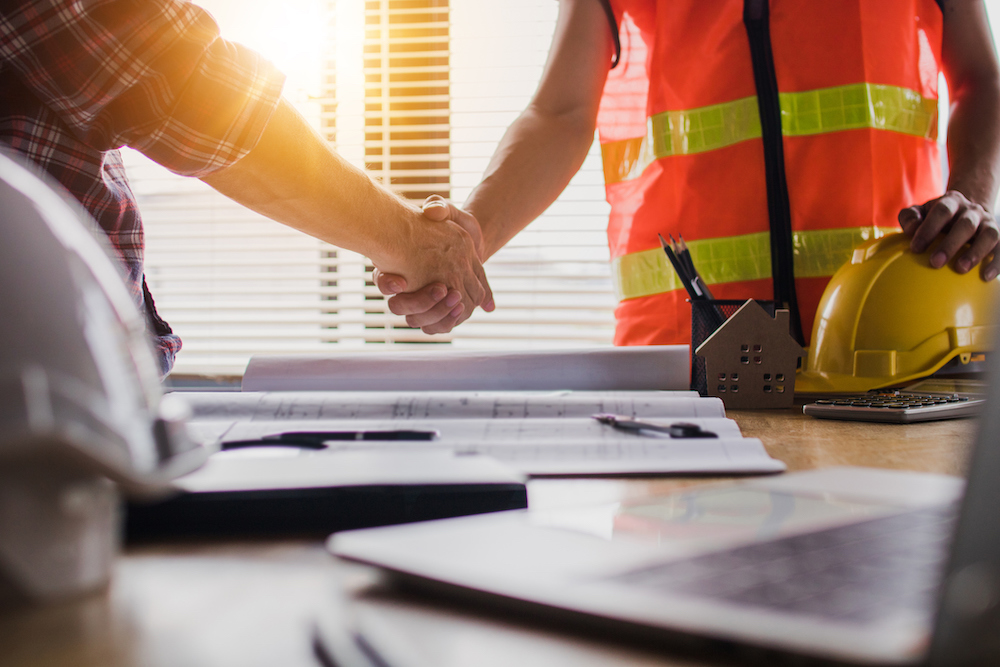 Construction project workers shaking hands