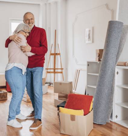 Couple hugging as they move home belongings.