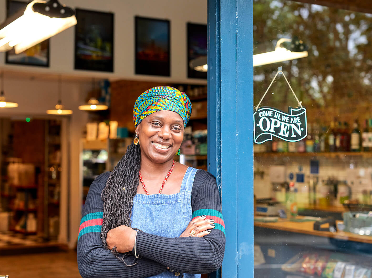 Small business owner standing in the doorway of her shop.