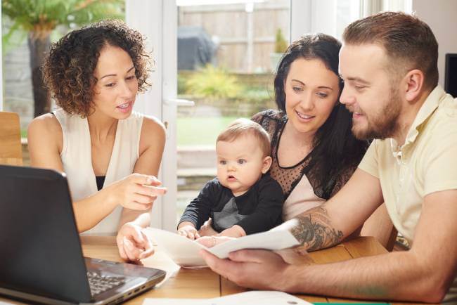 Parents of baby reviewing a daycare contract.