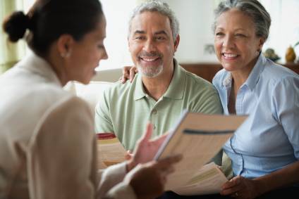 Couple getting estate planning advice from a lawyer regarding life insurance.