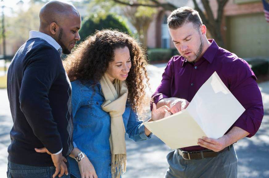 Couple talking to a lawyer about buying a house