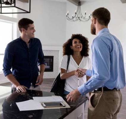 Woman shaking hands in real estate transaction.