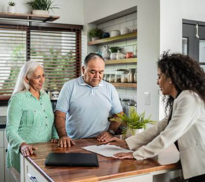 Coulple in kitchen with lawyer discussing the difference between a lease and a rental agreement.