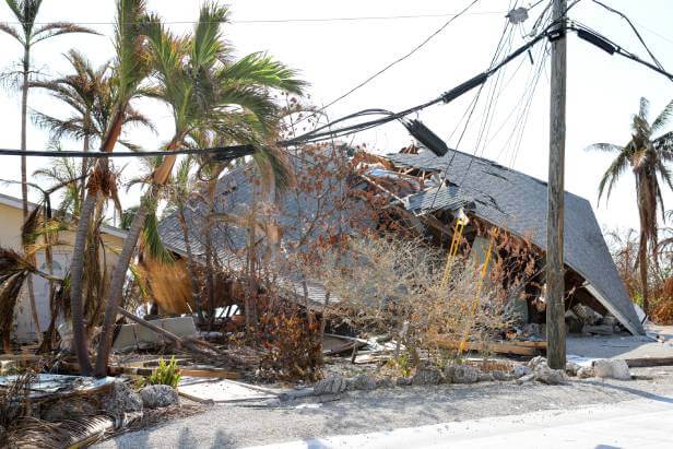 Hurrican damaged home that is almost flattened.